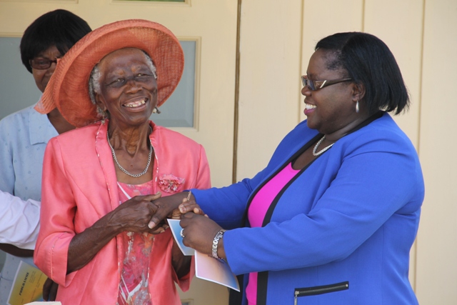 Marjorie Walters of Brick Kiln Village receives keys to her new home from Junior Minister in the Ministry of Social Development Mrs. Hazel Brandy-Williams on June 15, 2016, as part of the ministry’s Community Housing Programme